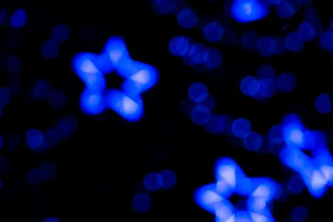 Defocused of phantom blue star bokeh blurred light from neon lighting bulb Foto stock