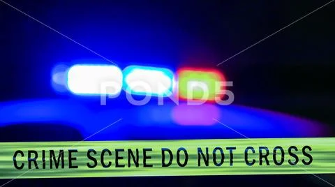 Defocused police car siren with boundary tape Stock Photos