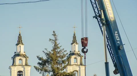 Defocused red hook of a crane on the background of the tower church with orth Foto stock