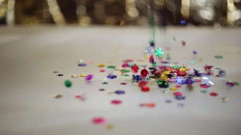 Defocused shimmering multicolored sequins falling down. Stock Footage 98309420