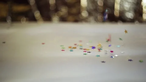 Defocused shimmering multicolored sequins falling down. Stock Footage 98312599