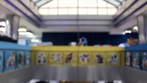 Defocused Shopping mall with different decorations and walking people. Camera Stock Footage 83332028