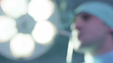 Defocused Shot of Doctor Smoking in Operating Room Stock Footage 59061856