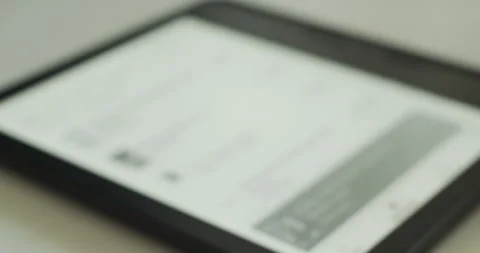 Defocused Shot of person using e-reader ebook device for reading books Stock Footage 279821918