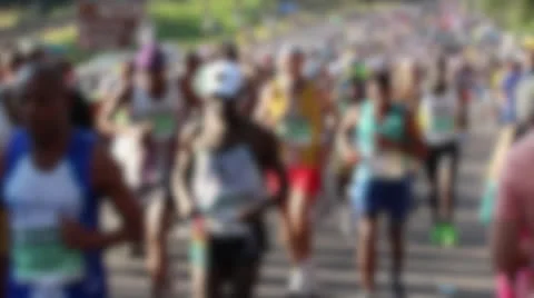 Defocused shot in slow motion of athletes running marathon Stock Footage 24690666