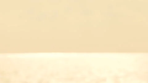 Defocused shot of small ripple wave in sea, shiny sparkling sunlight reflecti Stock Footage 130585568