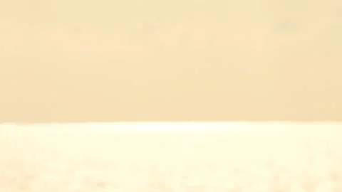 Defocused shot of small ripple wave in sea, shiny sparkling sunlight reflecti Stock Footage 130585630