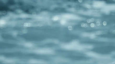 Defocused shot of a wavy water surface with a beautiful bokeh. Video stock 93149312