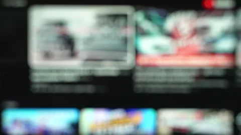 Defocused smart TV screen scrolling through a video streaming app interface with Video stock 346890414