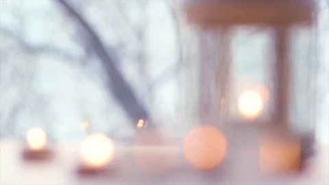Defocused snow background. Snow falls beautifully and candles are burning. Stock Footage 119471352