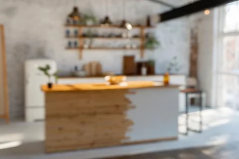 Defocused spacious open space loft industrial  kitchen studio interior with k Stock Photos