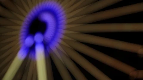 Defocused spiraling blue light show on a ferris wheel Stock Footage 120526970
