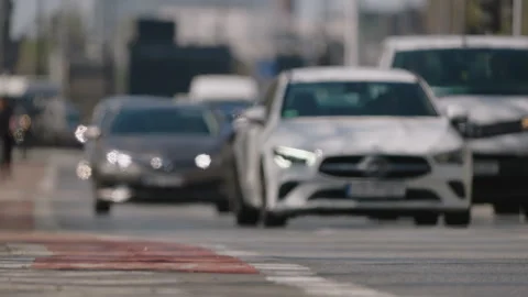Defocused traffic background with vehicles moving toward camera, low angle Stock Footage 333650682