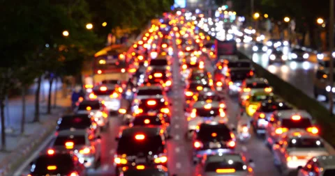 Defocused traffic jam red lights in Bangkok at night, arterial road Stock Footage 326387744