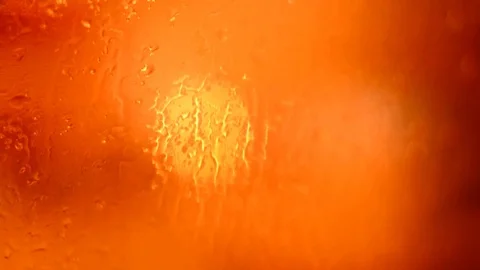 Defocused traffic lights through wet car glass. Stock Footage 73620202
