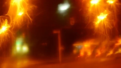 Defocused traffic lights through wet car glass. Stock Footage 73620219