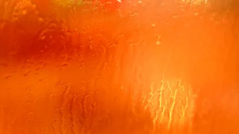 Defocused traffic lights through wet car glass - rainy night. Stock Footage 73620232