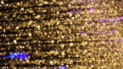 Defocused vertical LED garlands at night. Blurred glowing golden lights. Stock Footage 231424645