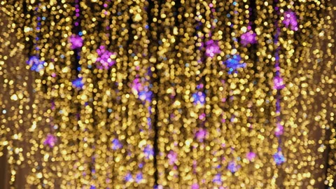 Defocused vertical LED garlands at night. Blurred glowing golden lights. Stock Footage 231424944