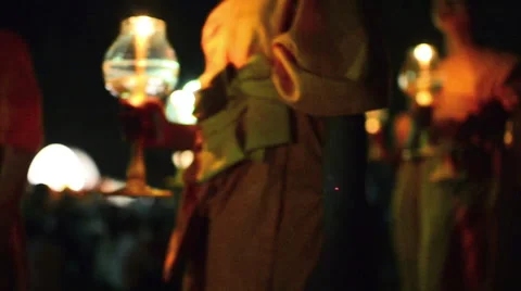 Defocused video of Buddhist monks walking, holding candles during the Yii Peng Stock Footage