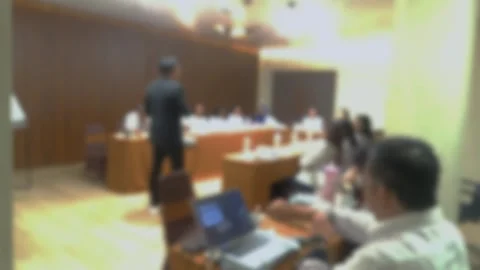 Defocused video of A presenter addresses an audience during a business meeting Stock Footage 340533814