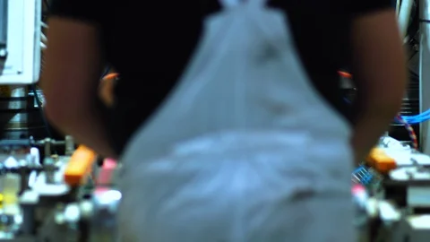 Defocused View Of Back Of Worker Feeding Glass Pane Into Rolling Machine. Stockbeeldmateriaal 125867065