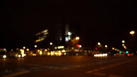 Defocused view of busy intersection with city traffic at night Stock Footage 122819044