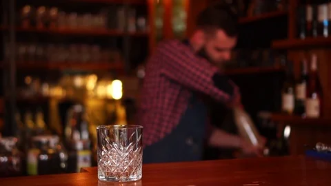 Defocused view on concentrated barman working behind bar counter with alcohol Stock Footage 103804128