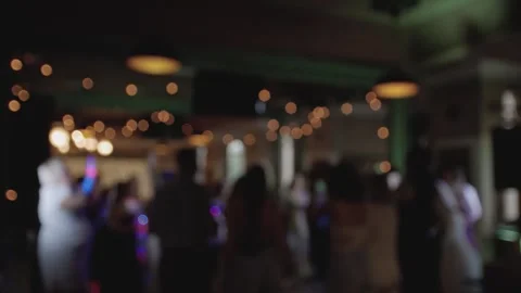 Defocused view of great wedding party with silhouettes of people dancing. Stock Footage 257618772