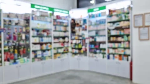 Defocused view inside of pharmacy with the seller counter, computer and cash reg Stock Footage 295867008