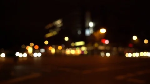 Defocused view of intersection in Berlin at night with oncoming traffic Video stock 120929863