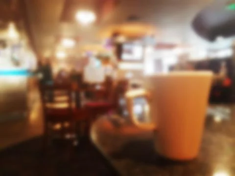 Defocused view of a mug on a table inside a bar pub cafe Stock Photos