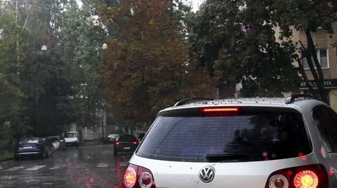 Defocused view through wet windshield while heavy rain in city. Driving on Stock Photos