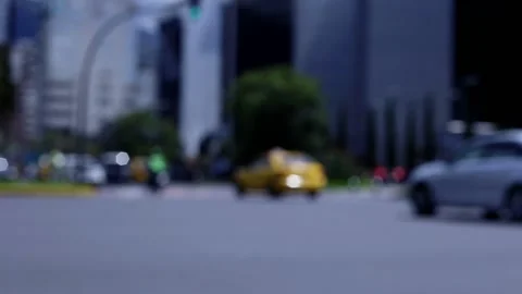 Defocused view of traffic driving down a large street in a city Stock Footage 155297553