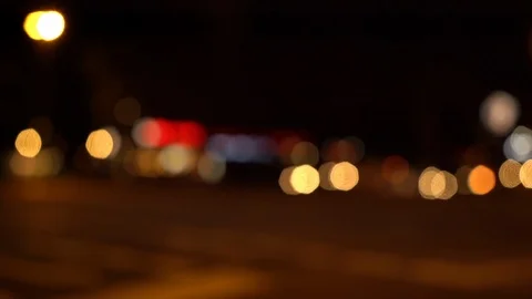 Defocused view of types of traffic passing by at night Stock Footage 122818983