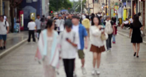 Defocused view, young couples walking on Guanghua street in Kunming, China Video stock 329624166