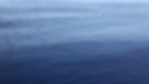 Defocused waves run on blue water surface Stock Footage 87261507