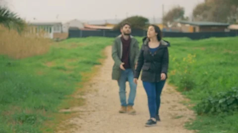 Defocused young lovers arguing violently in the park.Crisis,betrayal,break up Stock Footage 104957776