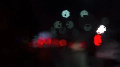 Defocussed blurry light from traffic with light rain water hitting front mirror Stock Footage 33376502
