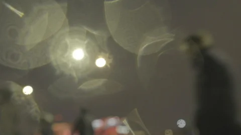 Defocussed commuters walking in the rain at night Video stock 118271233