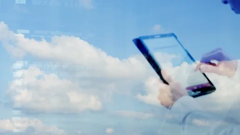 Defocussed reflection of a man using a tablet against a plain sky Video stock 87002962