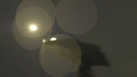Defocussed view of commuters at night in the rain on london bridge Stock Footage 96473560
