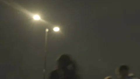 Defocussed view of commuters at night in the rain on london bridge Stock Footage 96481265