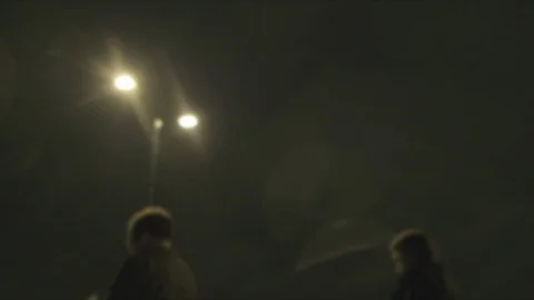 Defocussed view of commuters at night in the rain on london bridge Stock Footage 96514777