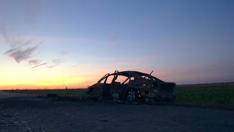 Deformed car from fire on the background of a blue sky. Consequences of a 動画素材 112712817