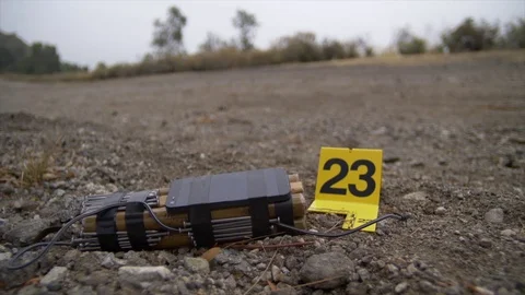 DEFUSED ROADSIDE EXPLOSIVE DEVICE IS NOW EVIDENCE AT A CRIME SCENE. Stock Footage 76412260