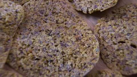 Dehydrated Fruit and Seed Cracker Surface Rotating on Wood, Macro Vídeo Stock 345611060