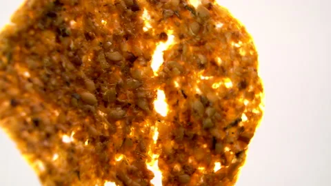 Dehydrated Fruit and Seed Crisp Rotating in Backlight, Macro View Vídeo Stock 345610992