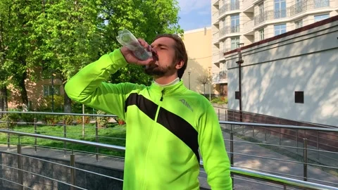 Dehydrated runner drinks last droplets of liquid from water bottle wanting more Stock Footage 192060334