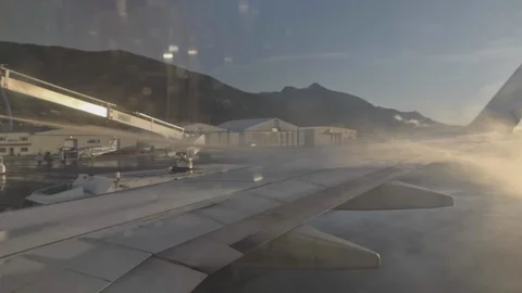 Deicing Agent Sprayed on Airliner Wing Passenger POV Slowmo Stock Footage 99664728